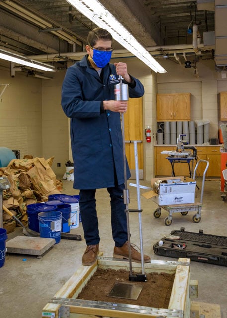 Ghabchi uses a dynamic cone penetrator to test density of base layer in test box