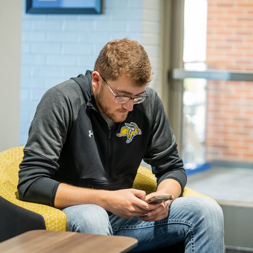 Student with cell phone in his hands