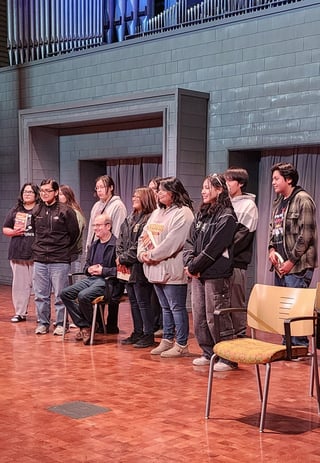 Flandreau Indian School students lined up on the stage before the lecture to speak with David Grann