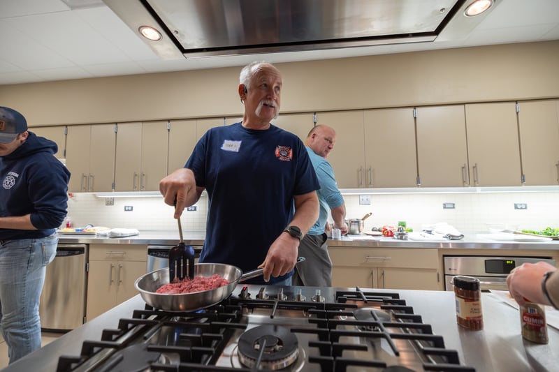 A firefighter cooking during the nutrition session of the Wellness Summit. 