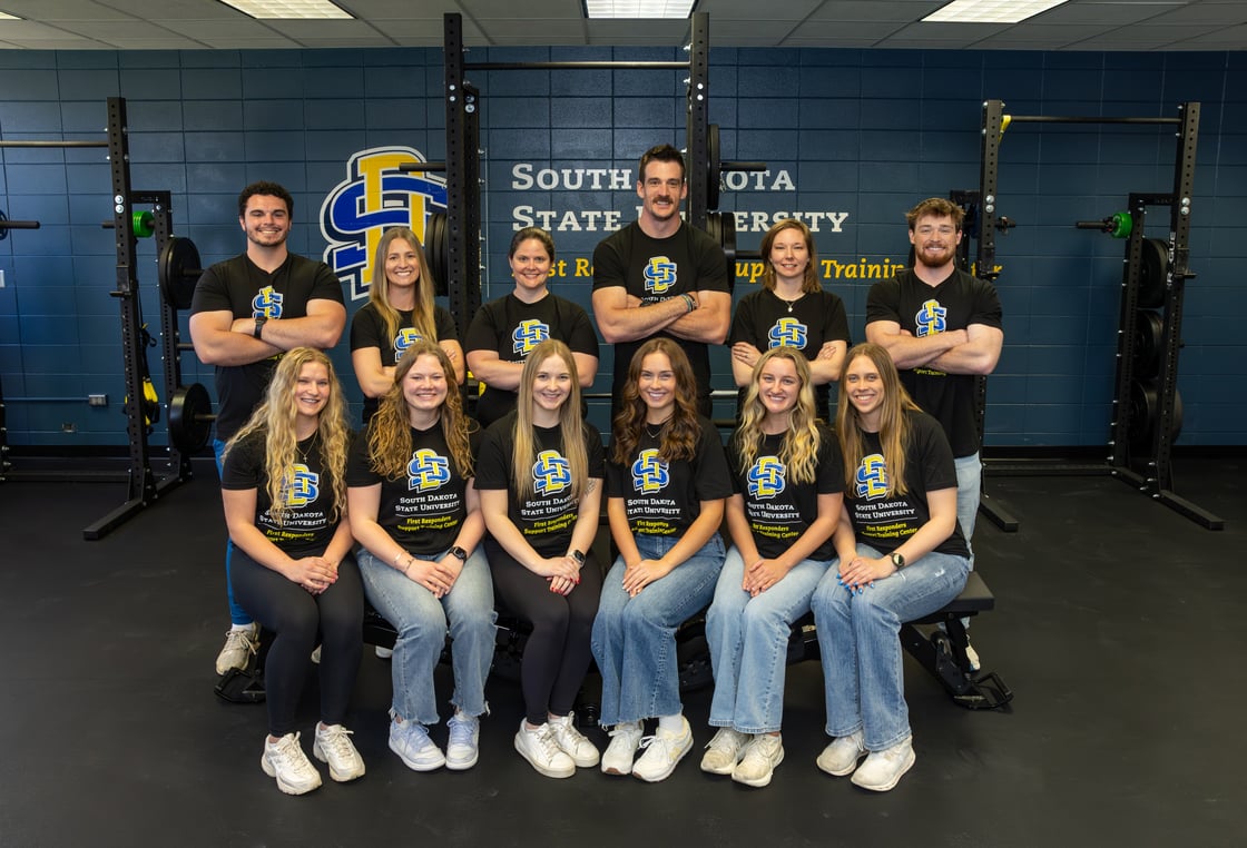 The FRST center team poses for a picture in front of the new lab space. 