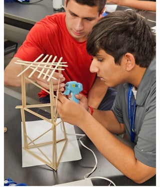  Students use balsa sticks to build a tower in a civil activity directed by Suzette Burckhard 