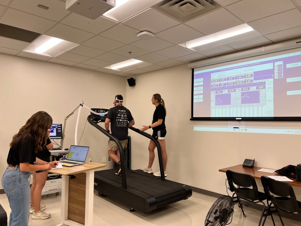 A research participant is pictured during their VO2 Max Test and also pictured is FRST Center research assistants performing their specific roles.