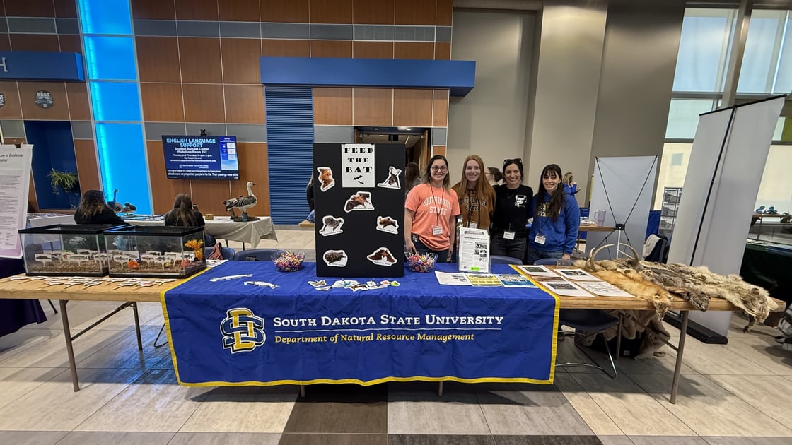 (left to right) Maddy Siller, Hannah Mulligan, Maya Pendleton, and Mercedes Batalla pose at the NRM booth.
