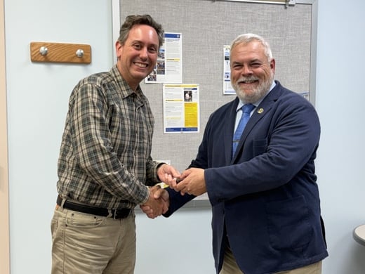 (from left) Josh Leffler and Joe Cassady are shaking hands.