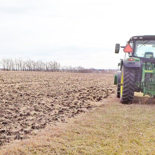 Plowed plots at Oak Lake Research Station with tractor on righthand side