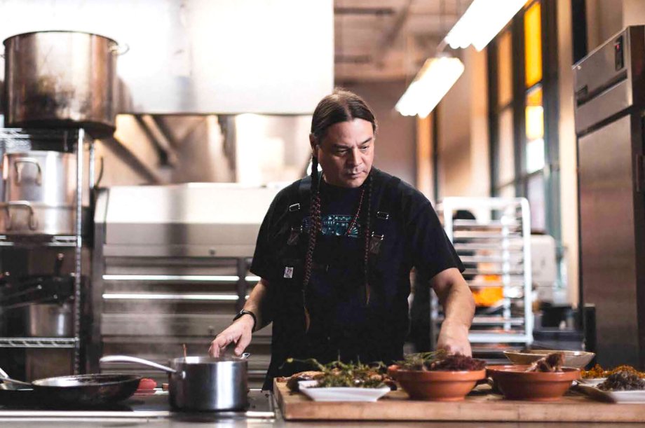 Sean Sherman the Sioux Chef in his restaurant kitchen with ingredients