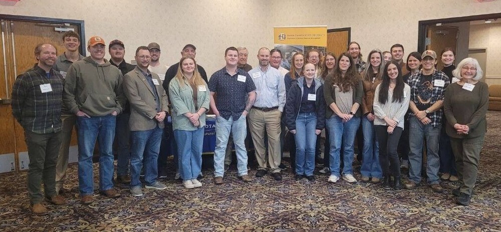 A large group of TWS members including NRM Wildlife faculty, along with graduate and undergraduate students, pose together for a group photo.